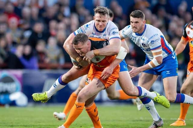 Castleford's Adam Milner is tackled by Wakefield's Matty Ashurst. Picture: Allan McKenzie/SWpix.com