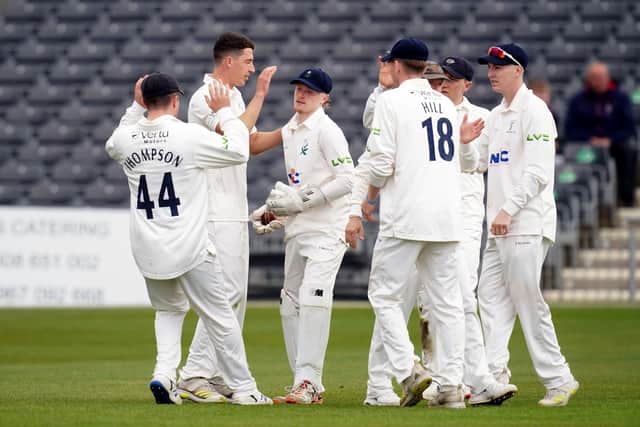 Yorkshire's Matthew Fisher celebrates taking the wicket of Gloucestershire's Ben Charlesworth with team mates during day one at Bristol. Picture: David Davies/PA