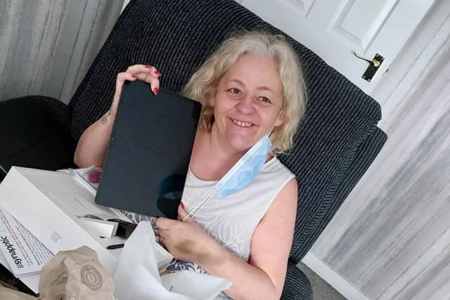 Sandra Lawrence, 58, with the Synapptic mobile device