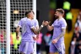 PUT IT THERE! Stuart Dallas, right, celebrates with Raphinha, left, after the Brazilian winger's strike put the Whites 1-0 up against Watford at Vicarage Road in their last game before the current break. Picture by John Walton/PA Wire.