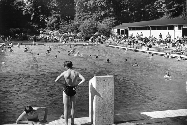 A busy swimming pool scene in June 1953.