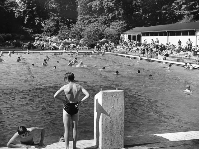 A busy swimming pool scene in June 1953.