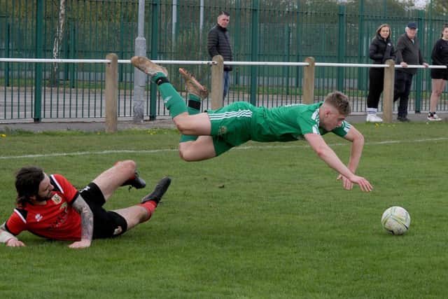 Beeston St Anthony's Ben Ellison-Tope takes a tumble after being fouled by Sam Cook of Knaresborough Town. Picture: Steve Riding.