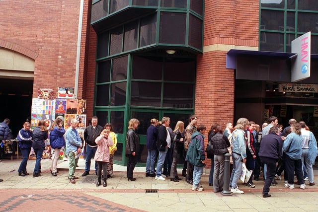 Fans queue outside HMV on Lands Lane to meet rockers Status Quo.