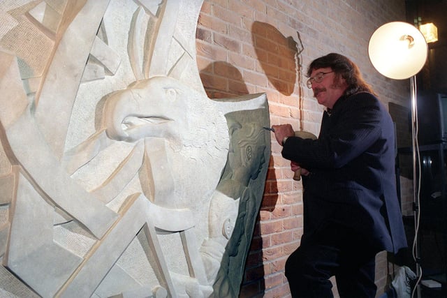 Stephen Hines, sculptor and teacher at Morley High, puts the finishing touch to a his piece of his work to mark the opening of the new part of the school, after the old building was destroyed by fire.