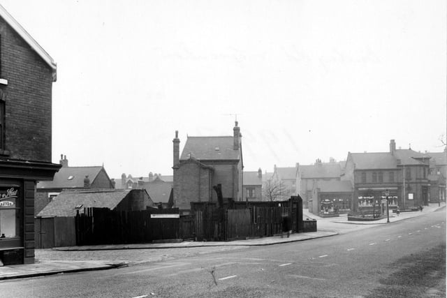 The south west side of Burley Road in January 1955.. To the left of the picture is 'A. Woodhouse & Sons, painters'. To the right of the picture, at the junction of Haddon Road, is the 'Leeds Industrial Co-operative Society Ltd'.