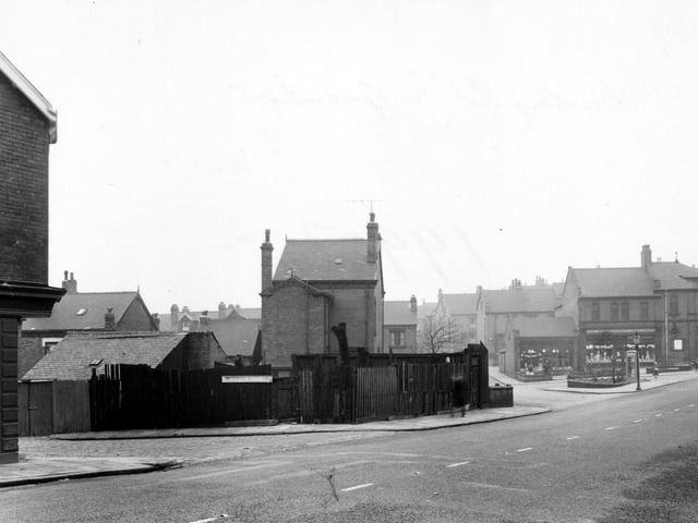 The south west side of Burley Road in January 1955.. To the left of the picture is 'A. Woodhouse & Sons, painters'. To the right of the picture, at the junction of Haddon Road, is the 'Leeds Industrial Co-operative Society Ltd'.