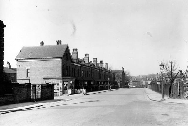 Cardigan Lane in April 1953.  There is possibly a playground opposite the newsagents. Also further down on the south east side is a taxi company probably belonging to 'Ives & Milner Ltd'.