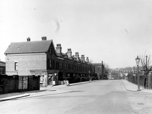 Cardigan Lane in April 1953.  There is possibly a playground opposite the newsagents. Also further down on the south east side is a taxi company probably belonging to 'Ives & Milner Ltd'.
