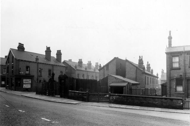 Burley Road, near the junction with Cross Greenhow Avenue, on the left, pictured in January 1955. At the junction is A. Woodhouse & Sons, painters.