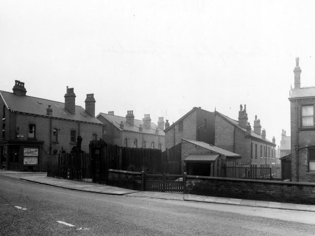 Burley Road, near the junction with Cross Greenhow Avenue, on the left, pictured in January 1955. At the junction is A. Woodhouse & Sons, painters.