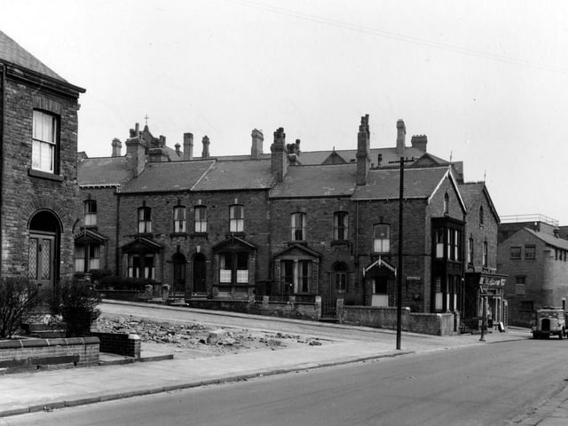 A view down Belle Vue Road in April 1955. Past Abyssinia Street there is a small grocers and off-licence with a lorry parked outside.