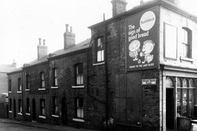 Back-to-back houses on Spring Grove Place stand to the left of this view from March 1959. A shop selling coal bricks seen on the right edge.