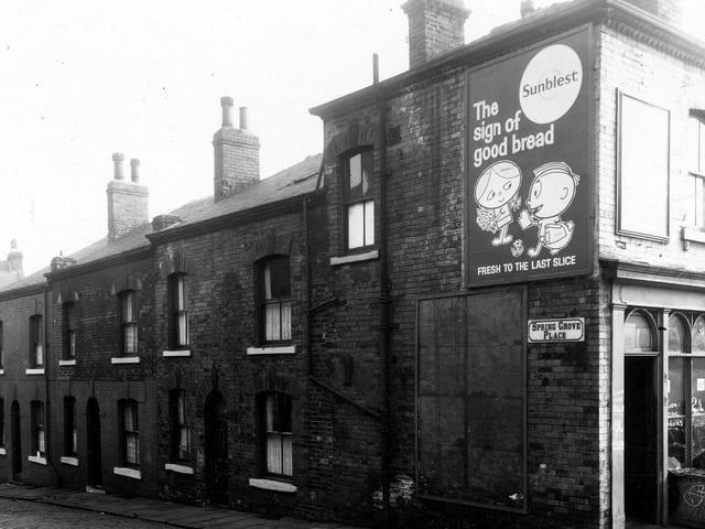 Back-to-back houses on Spring Grove Place stand to the left of this view from March 1959. A shop selling coal bricks seen on the right edge.