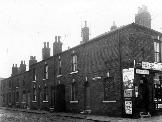Cross Eldon Place prior to demolition in January 1959. Many of the houses have been vacated and stripped of fittings. The grocers shop is on the corner with Wordsworth Street.