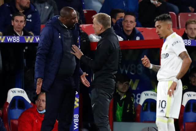 DISAGREEMENT: Crystal Palace boss Patrick Vieira, left, has words with fourth official Graham Scott after Wilfried Zaha had caught Leeds United winger Raphinha, right, with a hand to the face. Photo by IAN KINGTON/AFP via Getty Images.