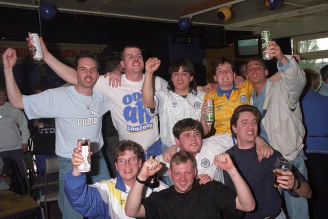 TheLeeds United Supporters Club celebrate inside Fullerton Park.