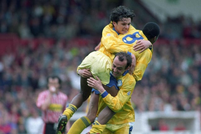 Rod Wallace and Gary Speed dive onto Gary McAllister.