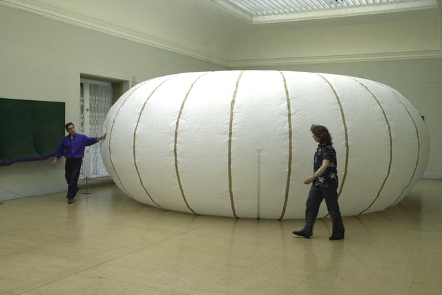 Artists Glenn Davidson and Anne Hayes inflate a giant doughnut shaped paper sculpture called a torus for YTV children's programme The Big Bang at the Leeds City Art Gallery.