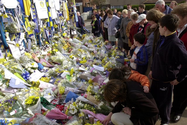 people crowd around tributes to Leeds United fans Kevin Speight and Christopher Loftus who were murdered in Turkey.