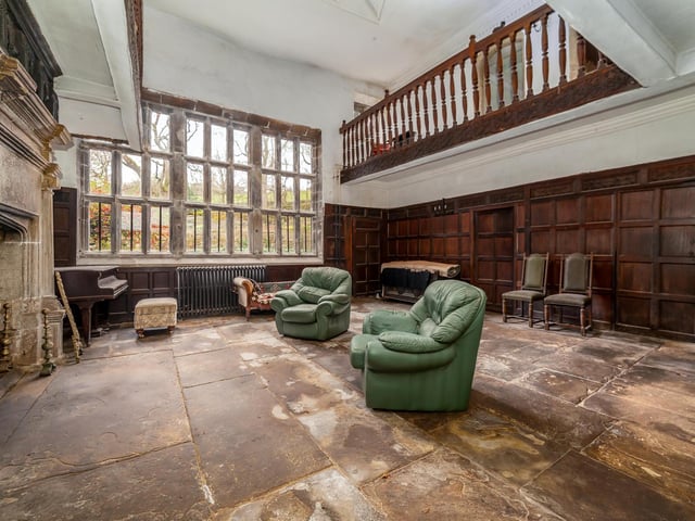 A massive stone fireplace and overhead gallery feature within the hall.