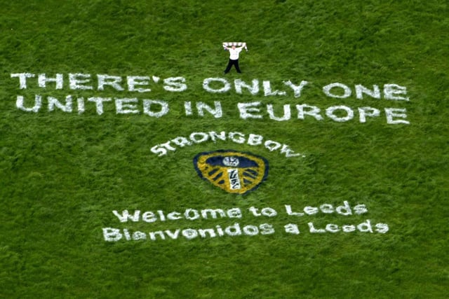 Ben Featherstone from Horsforth waves the Leeds flag above the message 'There's Only One United in Europe' in readiness for the Valencia team arriving at Leeds Bradford Airport ahead of the Champions League semi-final first leg clash at Elland Road.