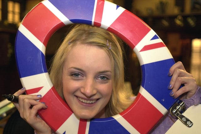 A series of celebrity toilet seats went up for auction to raise money for charity. Pictured is Emmerdale actress Nicola Wheeler with a toilet seat signed by the cast.
