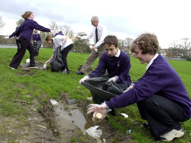 Howard Collier and Helen Smith with Year 9 pupils at Allerton Grange High clean up the school grounds as part of the Tidy Britain Groups 'Just Bin It' campaign.