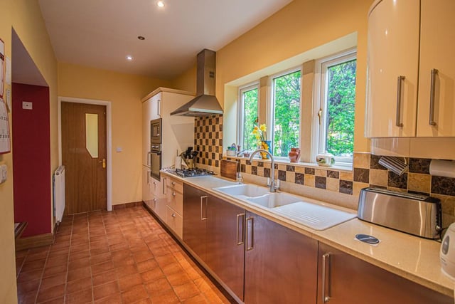 The fitted kitchen with plenty of natural light and open link, left, to the dining area.