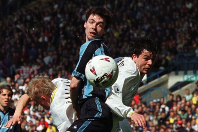 Coventry City's Gary Breen keeps his eye on the ball despite being sandwiched between Alf Inge Haaland and Ian Harte.