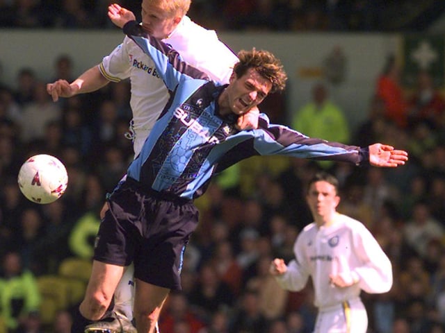 Alf Inge Haaland rises high to win the ball under pressure.