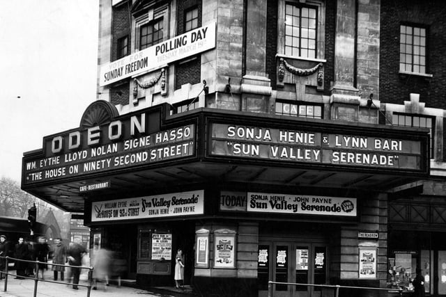 The Odeon Cinema with a clear view of the neon canopy, promoting the films 'The House on Ninety Second Street' and 'Sun Valley Serenade' in March 1946. Have you spotted the young cleaning lady with a mop in her hand?