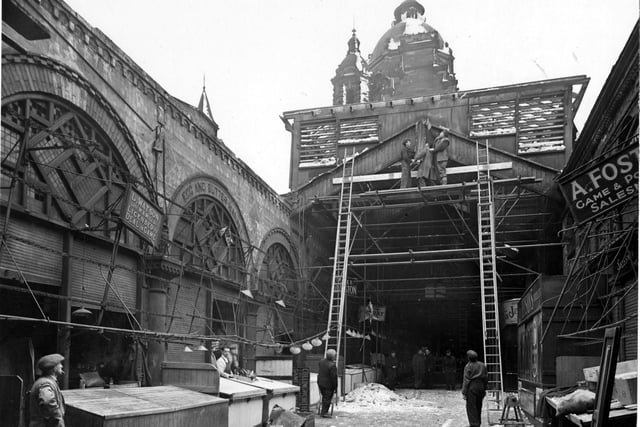 Roof repairs at Kirkgate Market in February 1947. This view looks along South Row (game). Signs for A.Foster (game and poultry), L.Watson (licenced to deal in game), and A.Cullingworth (game and poultry) can be seen.