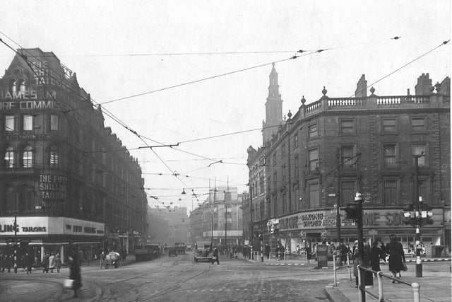 Boar Lane from Duncan Street, across the junction of Briggate and Lower Briggate in March 1943. The modern frontage of Saxone Shoes is on the right.