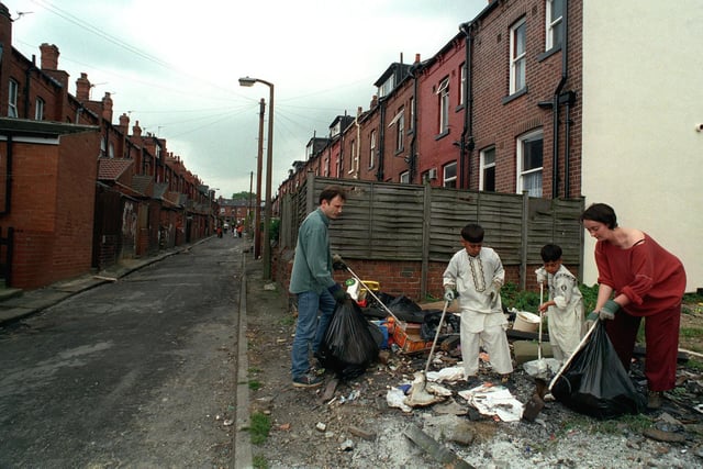 Harehills Matters a newly-formed community action group ,took part in a street clean-up. Pictured are local children helping Harehills Matters members Richard Gale and Karen Harris on Back Sandhurst Road in June 1999.