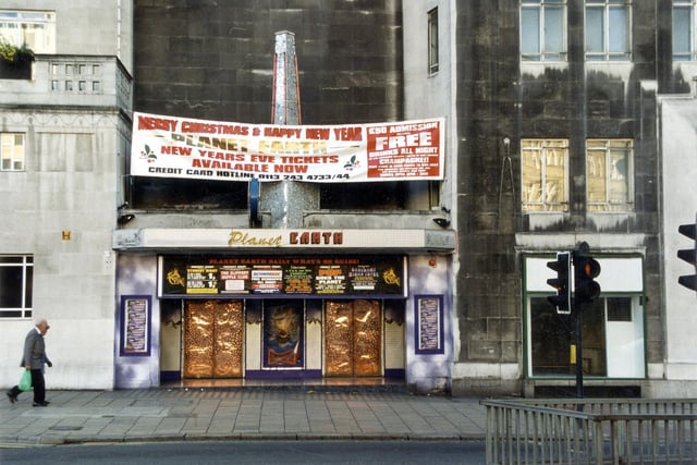 The entrance to Planet Earth night club which was in the basement of the Queens Hotel. There is a banner displayed advertising New Years Eve tickets'.