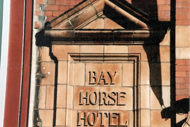 A stone plaque above entrance to Bay Horse Yard off Briggate pictured in September 1999. The inscription reads 'Bay Horse Hotel - Molineaux' (Molineaux is the name of a former licensee) The pub no longer exists.
