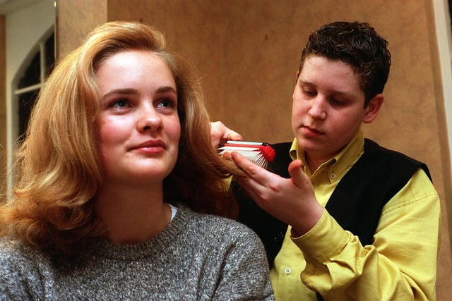 Schoolboy Andy Wrigglesworth puts the finishing touches to Esther McGowan's hair at John Allen Hairdressing in Horsforth. The 14-year-old worked part-time at the salon in December 1996.