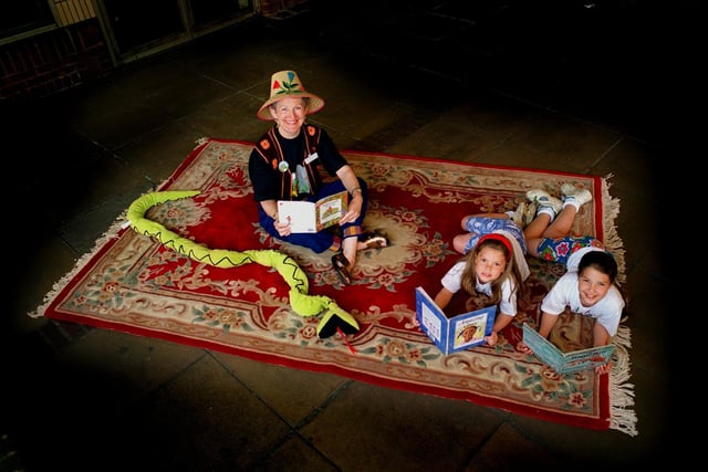 A 'magic carpet' travelled around libraries in Leeds encourage children to explore exotic locations through books. Pictured is Leeds children's librarian Margaret Devine reading books on the 'Magic Carpet' at Moor Allerton Library with sisters Kate and Alice Wadkin.