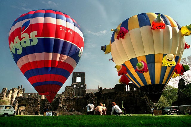 Dave Farrar (left) and Chris Oxby are watched by passers-by as they inflate their hot air balloons in-front of Kirkstall Abbey.