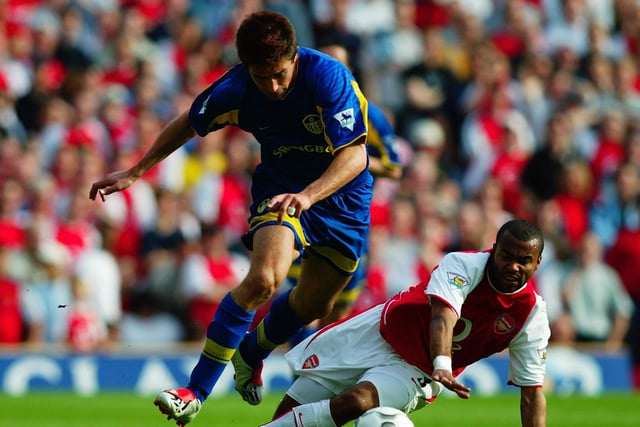 Harry Kewell skips past the challenge from Arsenal's Ashley Cole