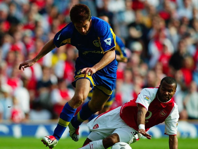Harry Kewell skips past the challenge from Arsenal's Ashley Cole