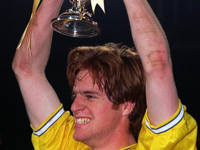 Alan Maybury lifts the trophy.