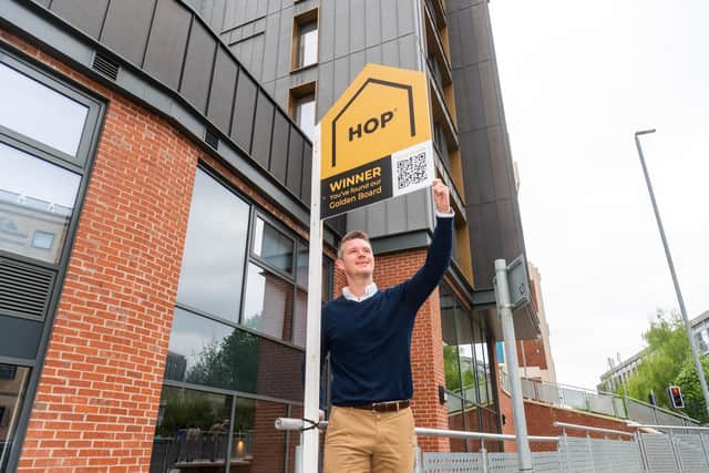 Luke Gidney, managing director at Leeds estate agent HOP, pictured with one of the golden boards. Picture: James Hardisty