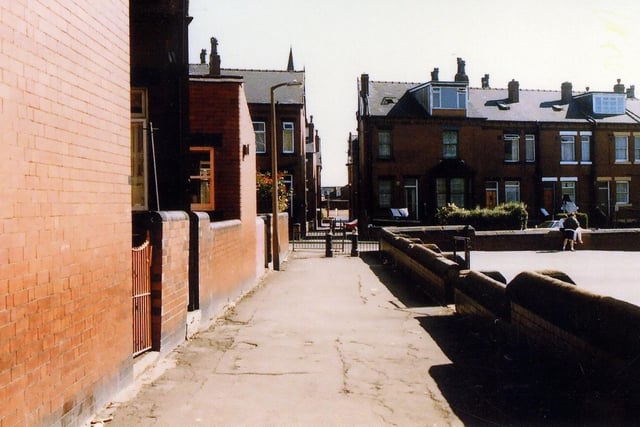 A ginnel running between the back of Maud Avenue and the boundary wall of Cross Flatts School, which crosses Harlech Road then Burlington Road before eventually leading out onto Tempest Road.