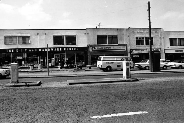 A parade of shops on Dewsbury Road in July 1980. On the left is a double fronted D.I.Y and hardware centre, then Class Carpets. Moving right a credit lending service, then a washeteria laundrette.