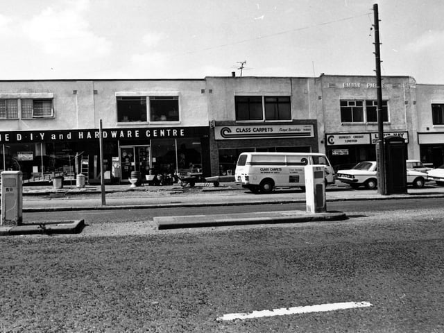 A parade of shops on Dewsbury Road in July 1980. On the left is a double fronted D.I.Y and hardware centre, then Class Carpets. Moving right a credit lending service, then a washeteria laundrette.
