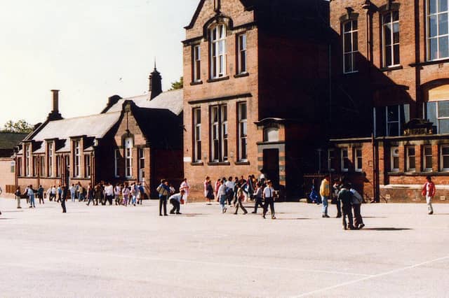 Playtime at Cross Flatts Park School on Harlech Road, probably taken around 1989 at the time that it was Cross Flatts Park Middle. Previously it had been a primary school, with separate buildings for infants and juniors; the infants school was the small building on the left, while the junior school was the two storey building.