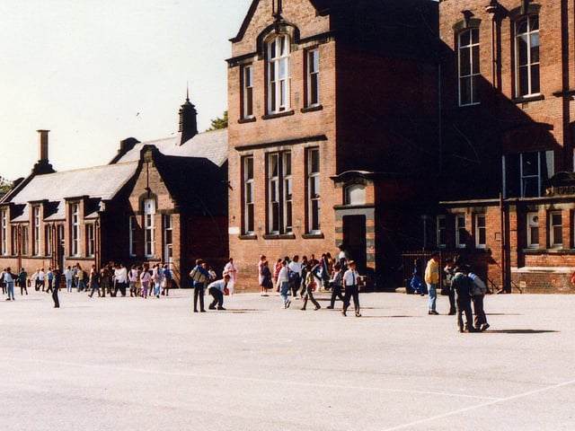 Playtime at Cross Flatts Park School on Harlech Road, probably taken around 1989 at the time that it was Cross Flatts Park Middle. Previously it had been a primary school, with separate buildings for infants and juniors; the infants school was the small building on the left, while the junior school was the two storey building.