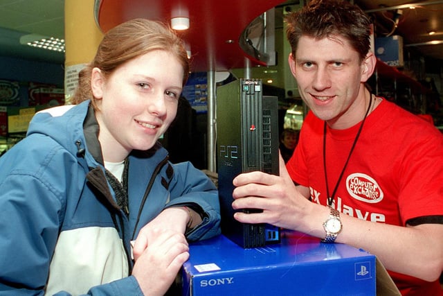 A Playstation 2 was one of the 'must have' Christmas presents. Pictured is Catherine Taylor snapping a console up for her boyfriend at the Computer Exchange. She is served by sales assistant Angus Cunningham.